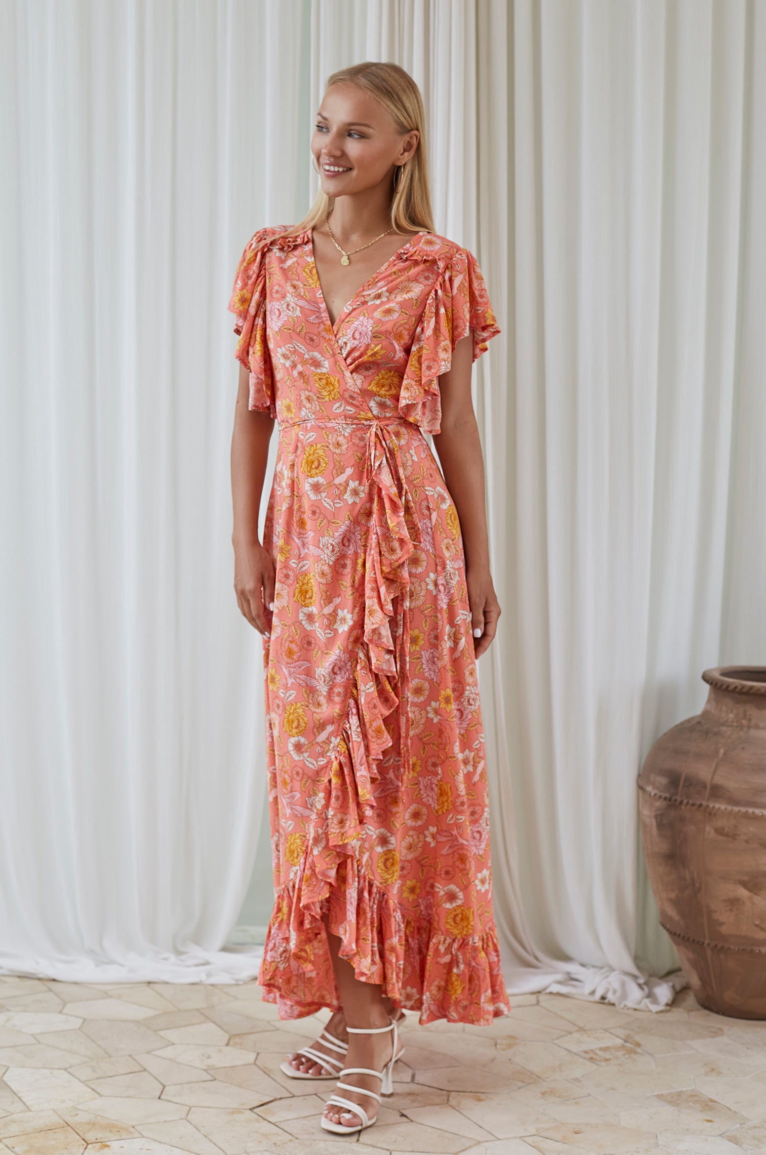 Carmen Wrap Maxi Dress featuring a soft rayon fabric, frilled hem, and a self-fabric tie at the waist, perfect for stylish occasions.