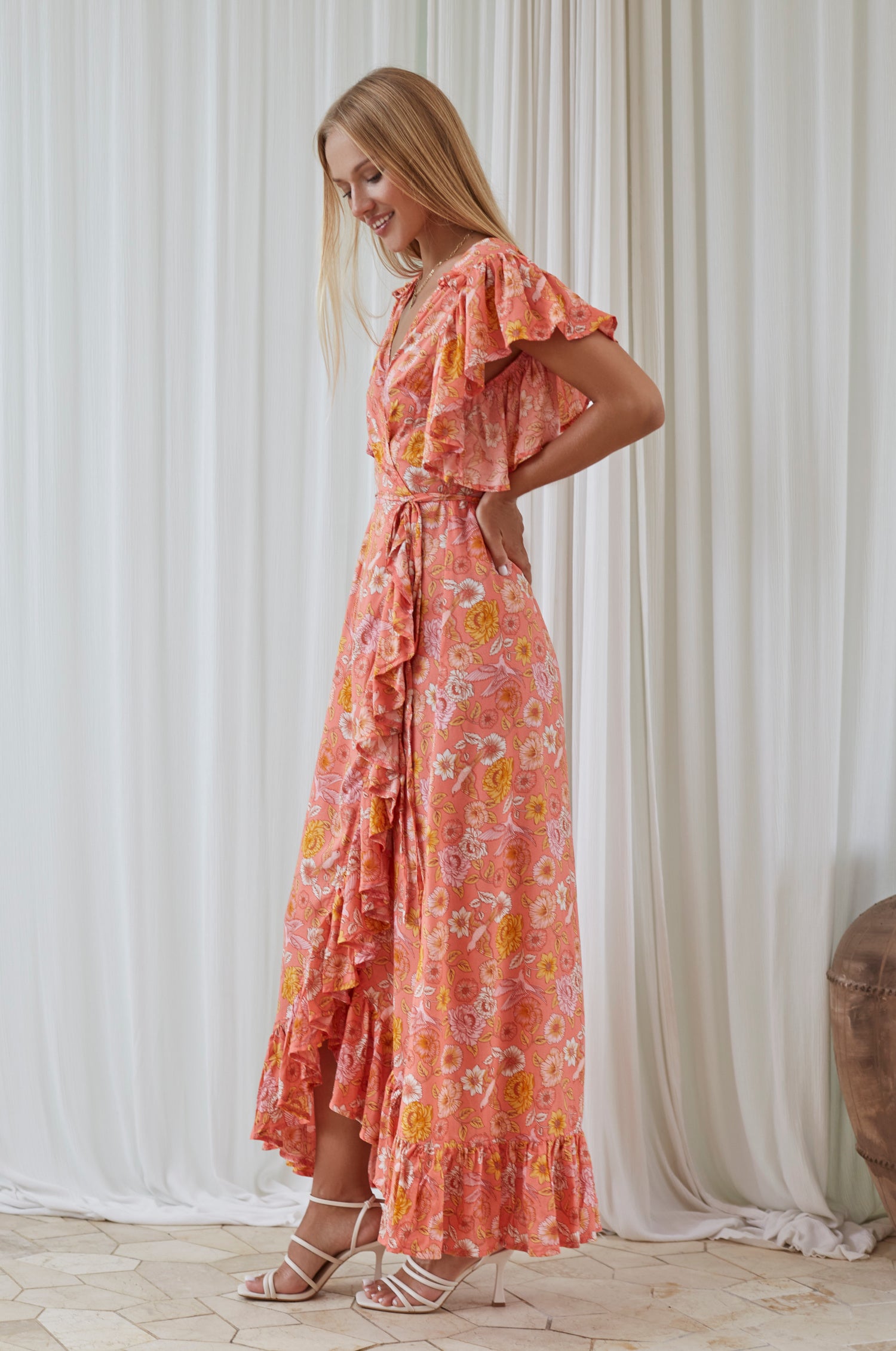 Carmen Wrap Maxi Dress featuring a soft rayon fabric, frilled hem, and a self-fabric tie at the waist, perfect for stylish occasions.