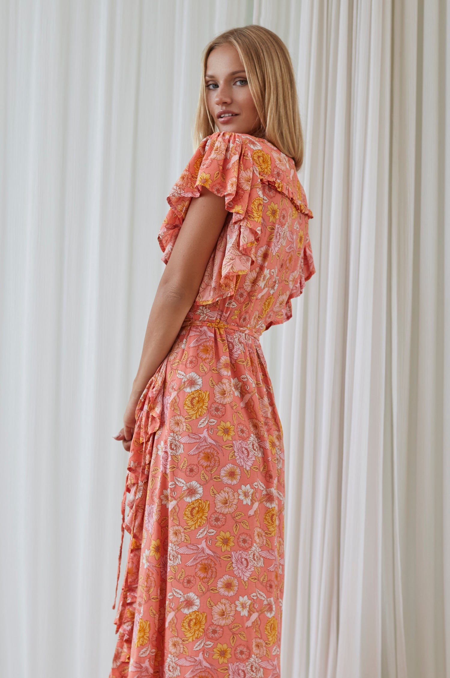 Carmen Wrap Maxi Dress featuring a soft rayon fabric, frilled hem, and a self-fabric tie at the waist, perfect for stylish occasions.