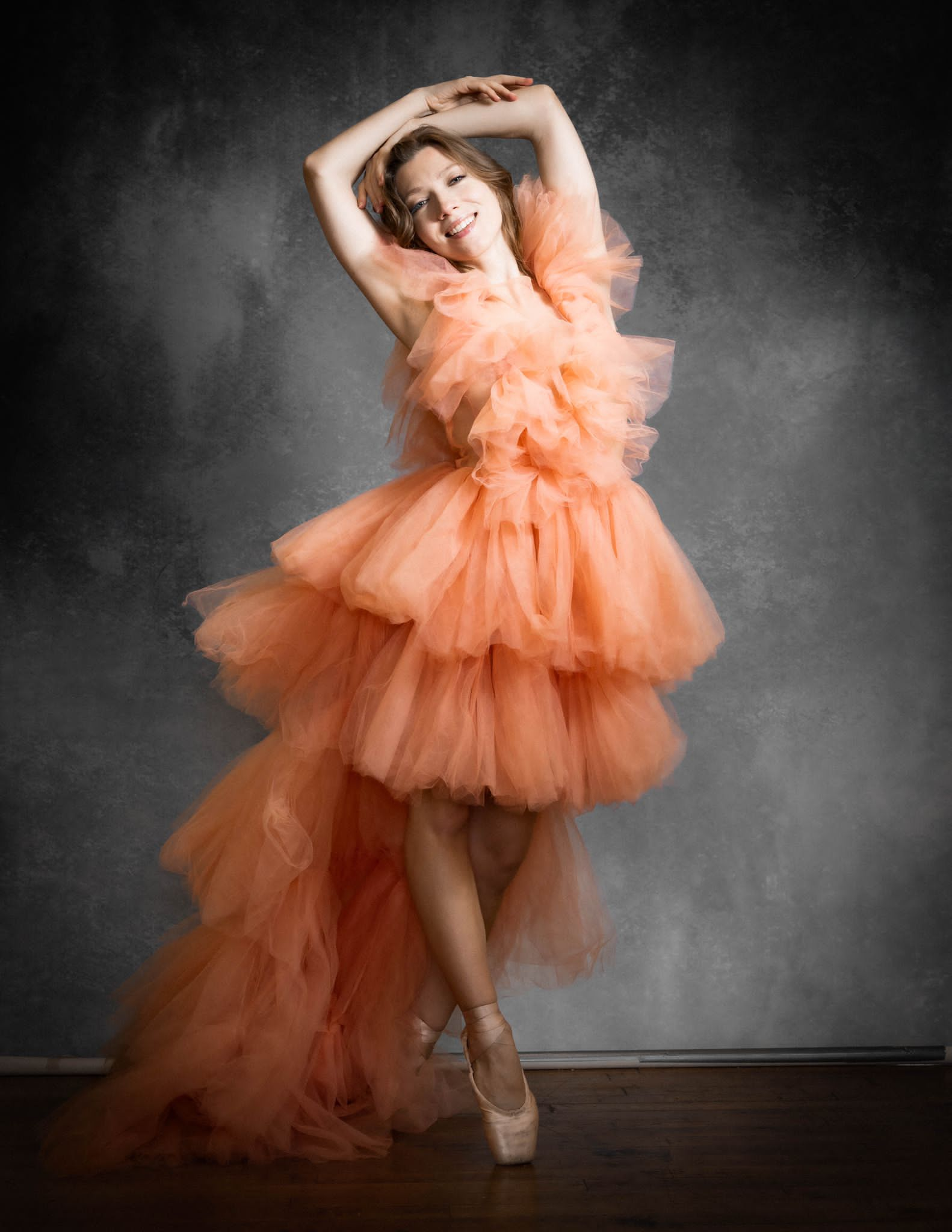 A beautiful high-low layered tulle dress in soft fabric, showcasing a flowing design perfect for elegant occasions.