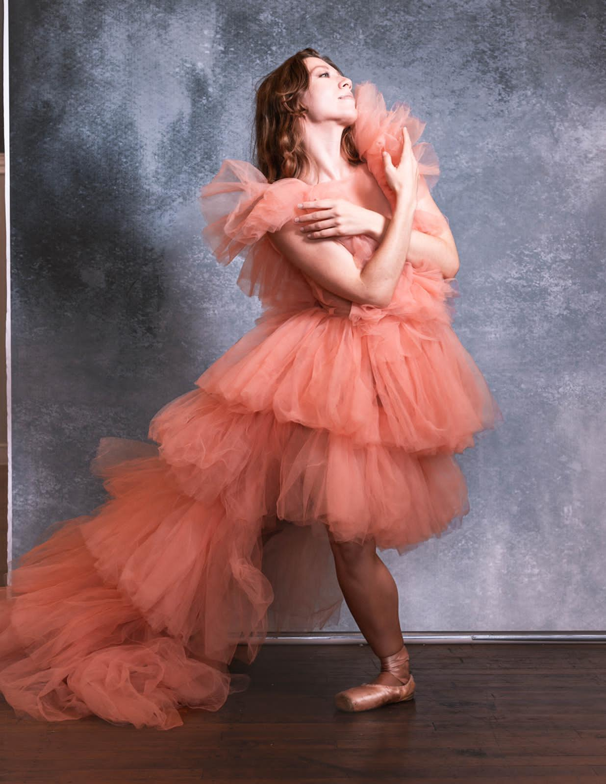 A beautiful high-low layered tulle dress in soft fabric, showcasing a flowing design perfect for elegant occasions.