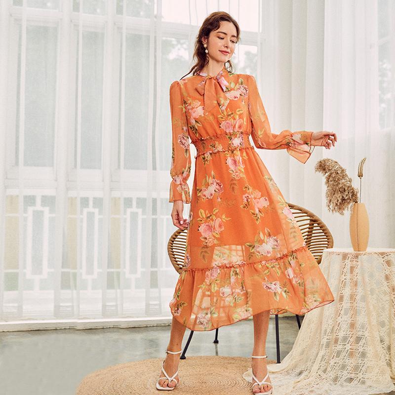 A stylish boho women chiffon dress featuring a bow neckline, trumpet sleeves, and floral patterns, perfect for summer occasions.