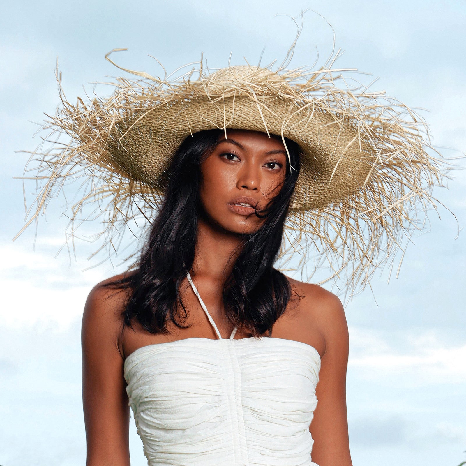 CATALINA Frayed Straw Hat in Nude with wide brim and frayed edge, handcrafted from straw by artisans in Java.