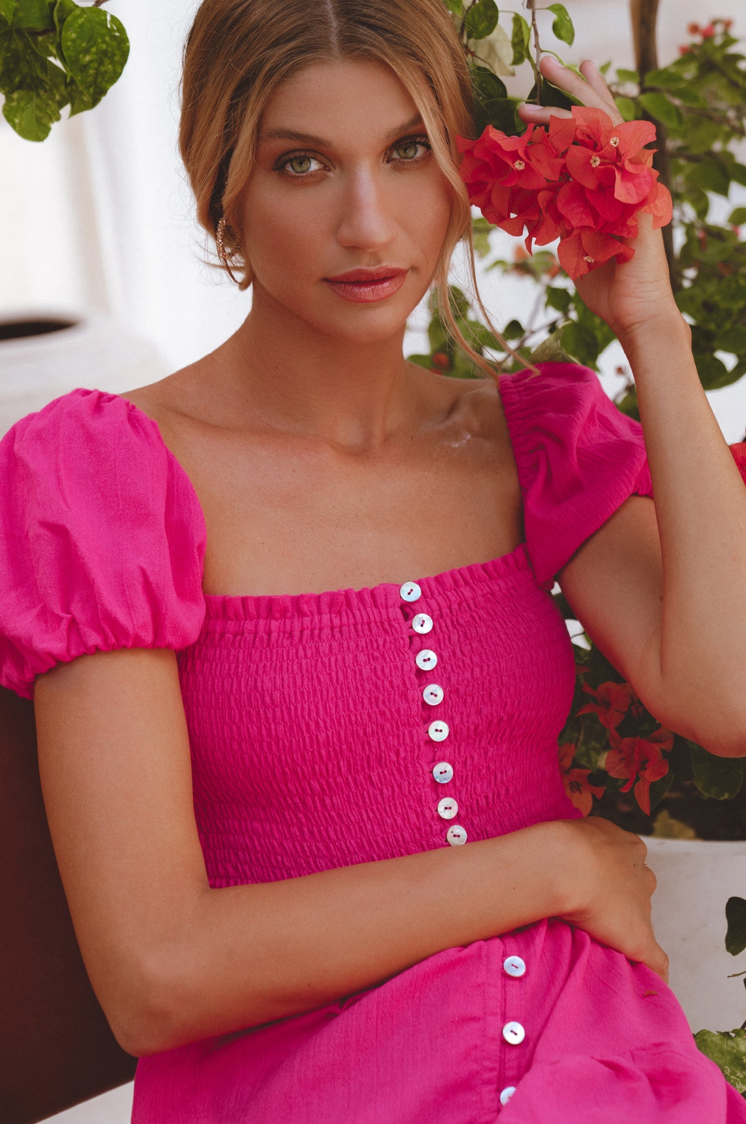 Catalina Smocked Linen Mini Dress featuring a smocked bodice, ruffles, and petite shell buttons in a summery color.