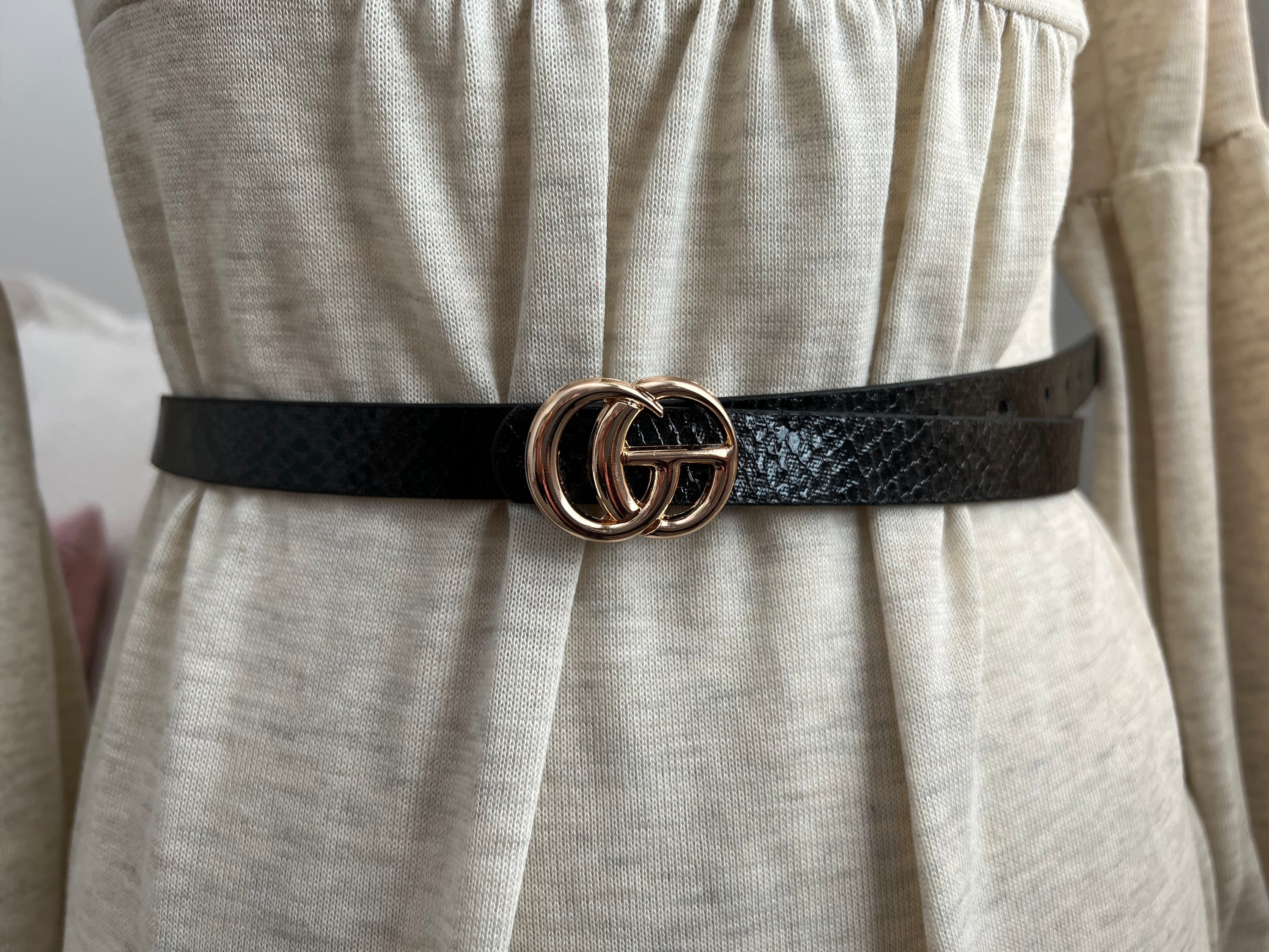 A stylish CG inspired snakeskin belt, 5/8” wide, adjustable fit for sizes up to 2x, showcasing a unique snakeskin pattern.