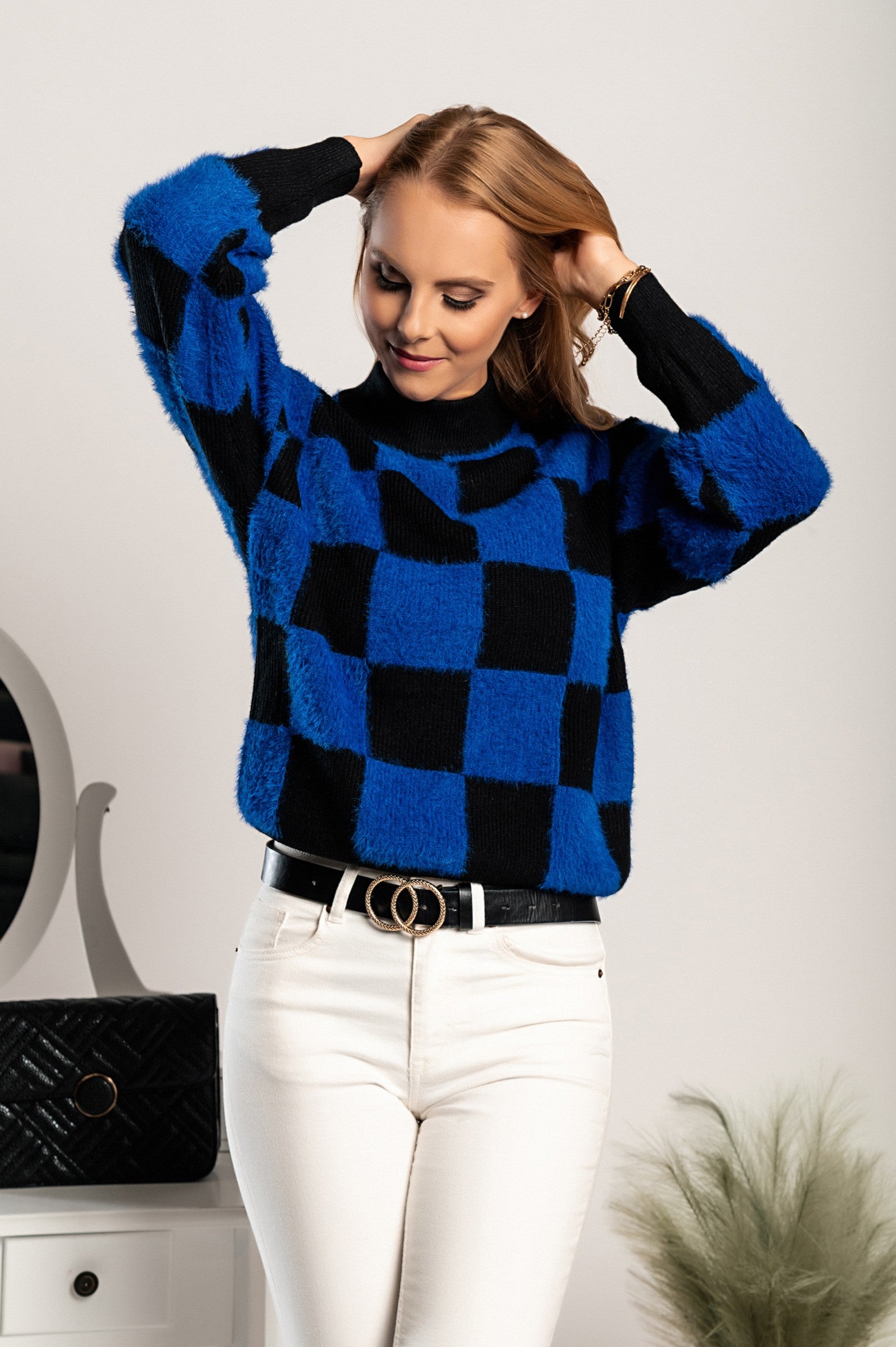 Blue-black checkerboard print sweater with long sleeves and round neckline, showcasing a stylish and comfortable design.