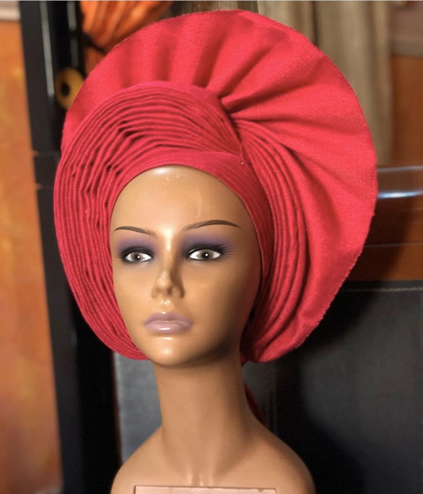 A vibrant Cherry Head Wrap made from premium asooke fabric, showcasing intricate patterns and colors, perfect for stylish hair management.