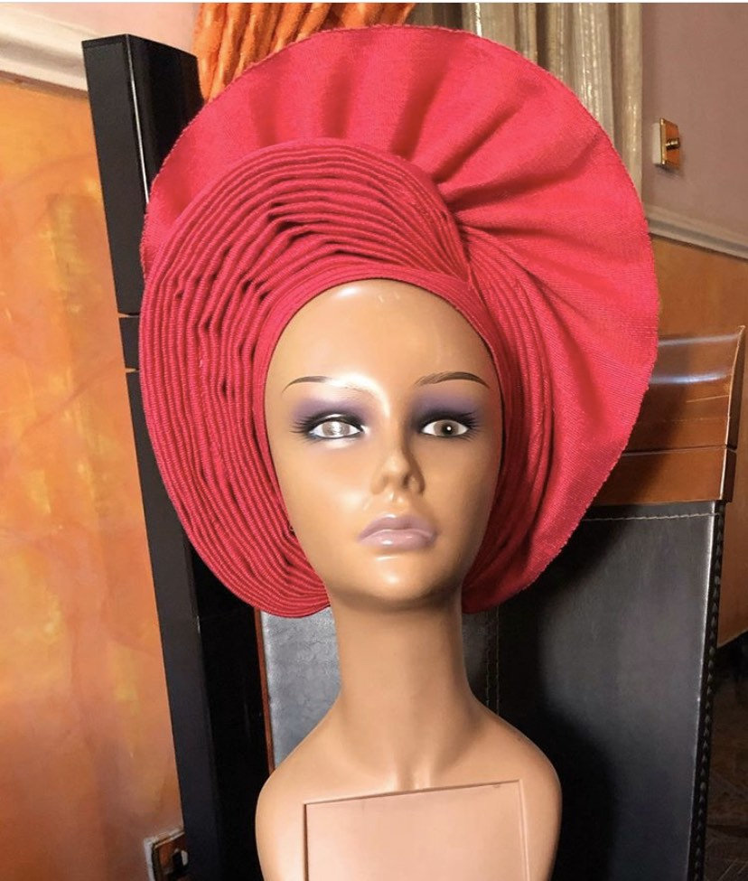 A vibrant Cherry Head Wrap made from premium asooke fabric, showcasing intricate patterns and colors, perfect for stylish hair management.