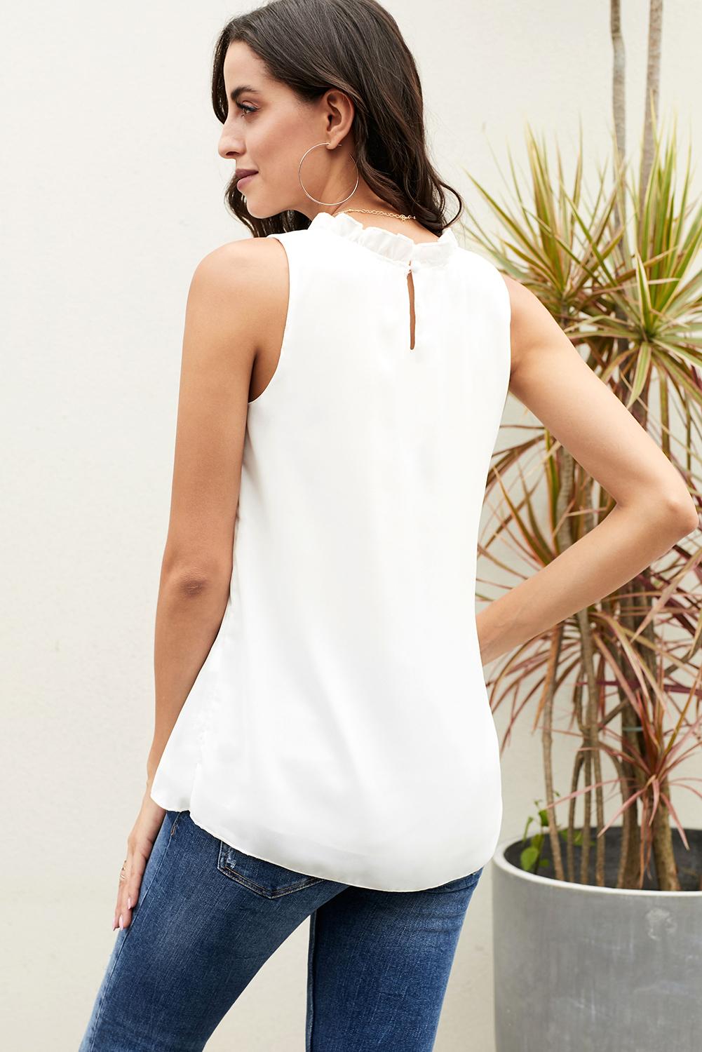 Chic white tank top featuring ruffle trim neckline and pleated detailing, perfect for summer wear.