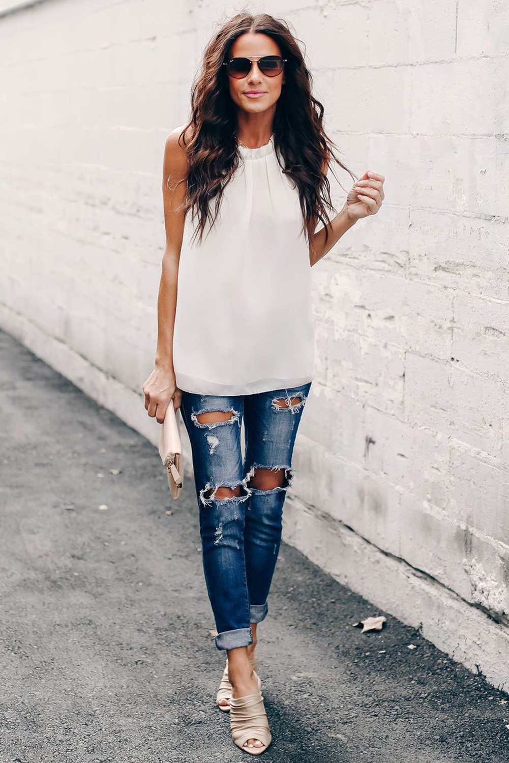 Chic white tank top featuring ruffle trim neckline and pleated detailing, perfect for summer wear.