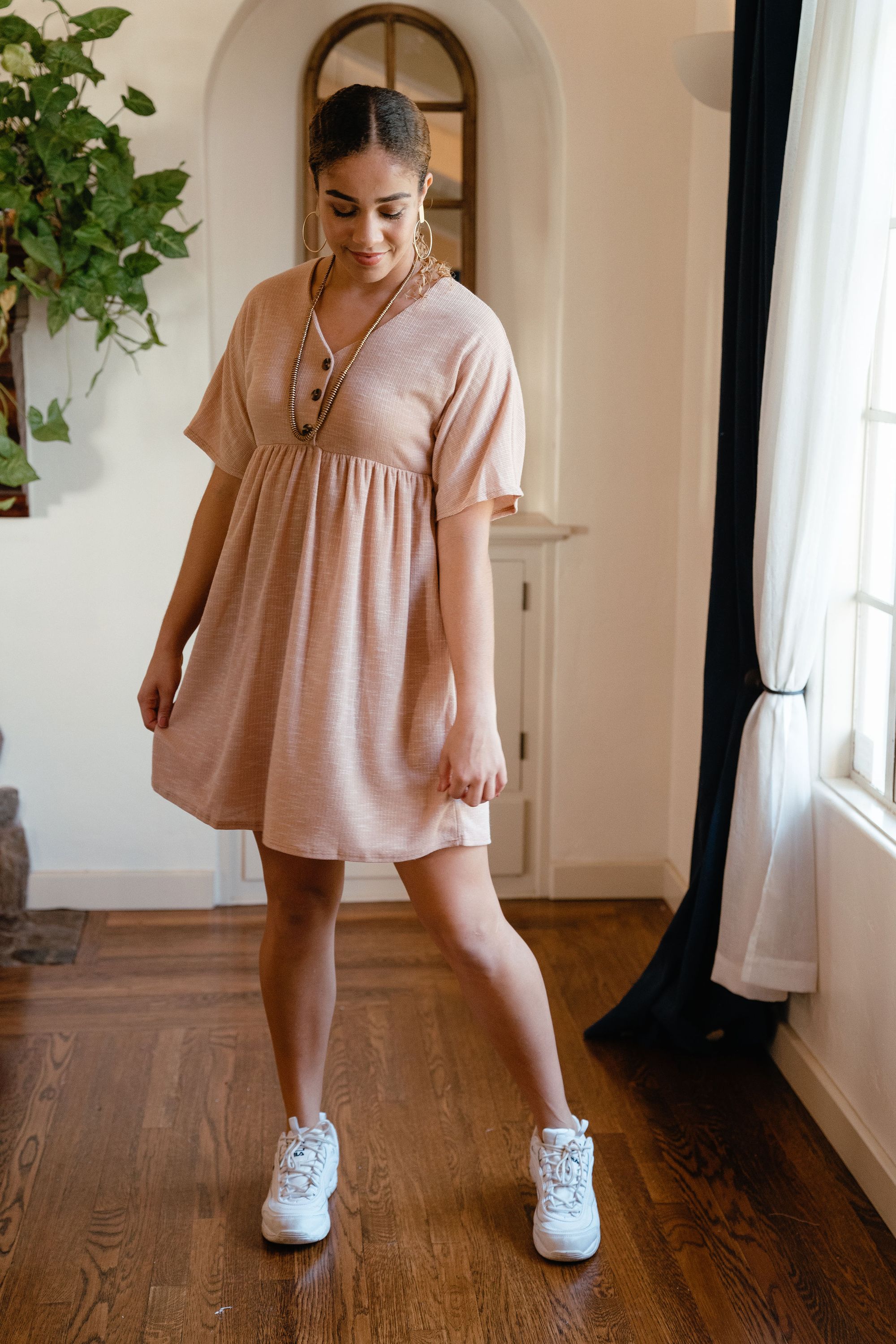 Chloe Dress in Taupe featuring a delicate neckline and button details, perfect for spring styling.