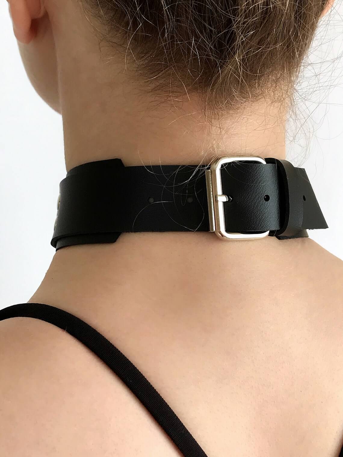 Close-up black leather choker.