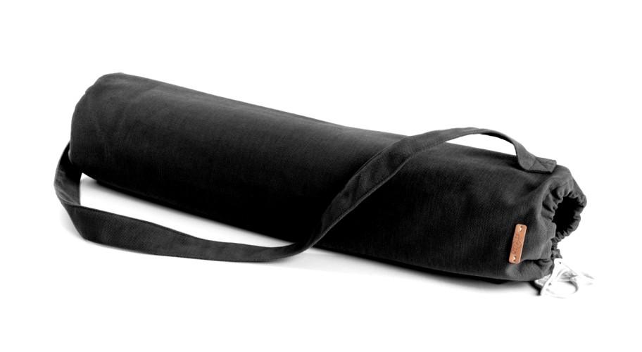 A vibrant Christmas-themed yoga mat featuring festive artwork, with a solid black textured back for grip, accompanied by a black carrying bag.