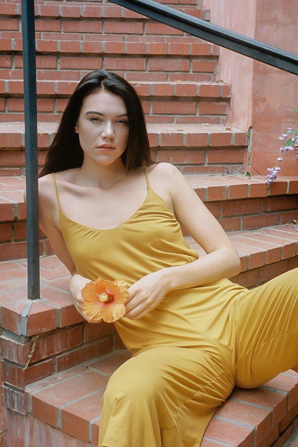 A stylish honey-colored jumpsuit with a flattering silhouette, perfect for warm weather, displayed on a model.