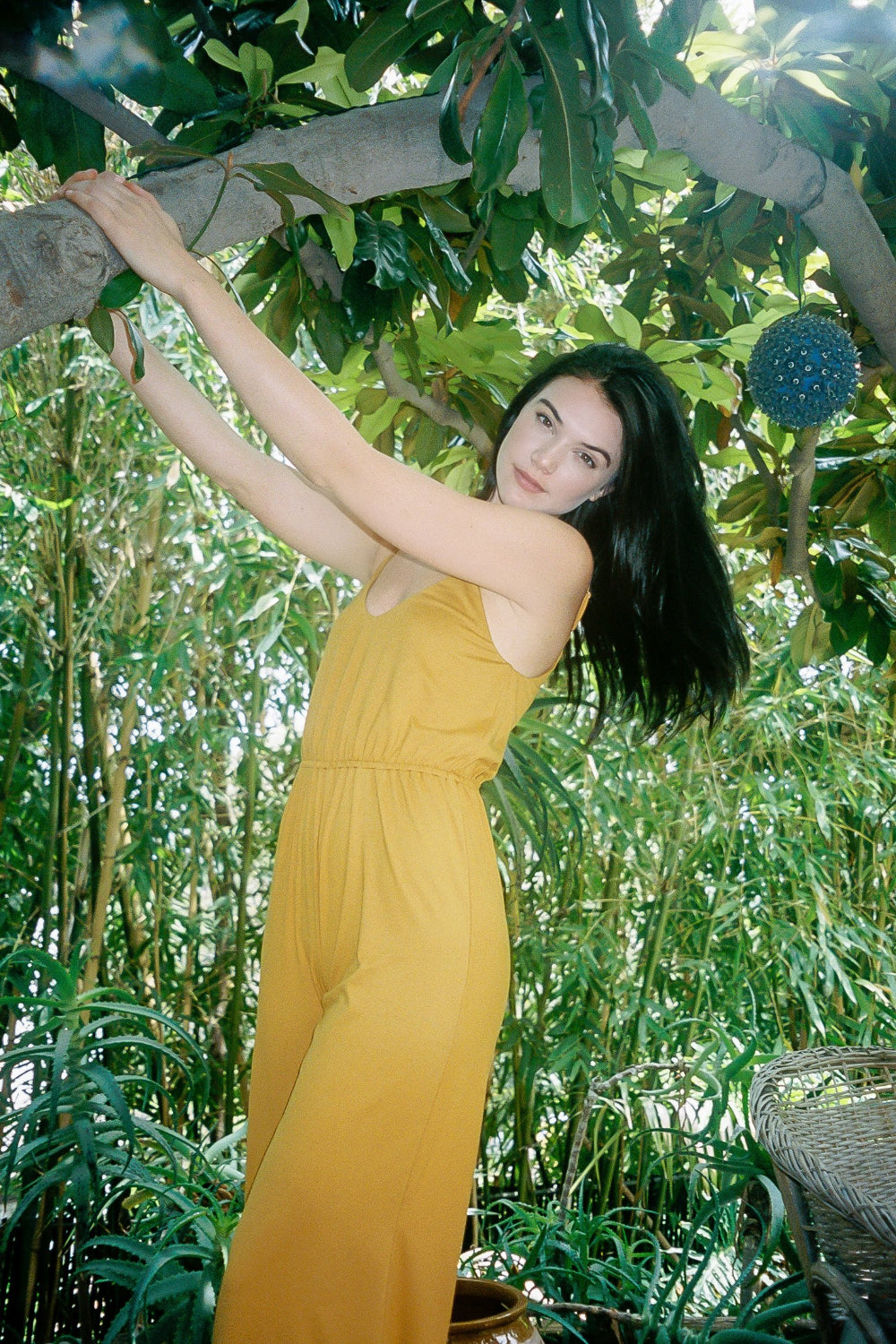 A stylish honey-colored jumpsuit with a flattering silhouette, perfect for warm weather, displayed on a model.