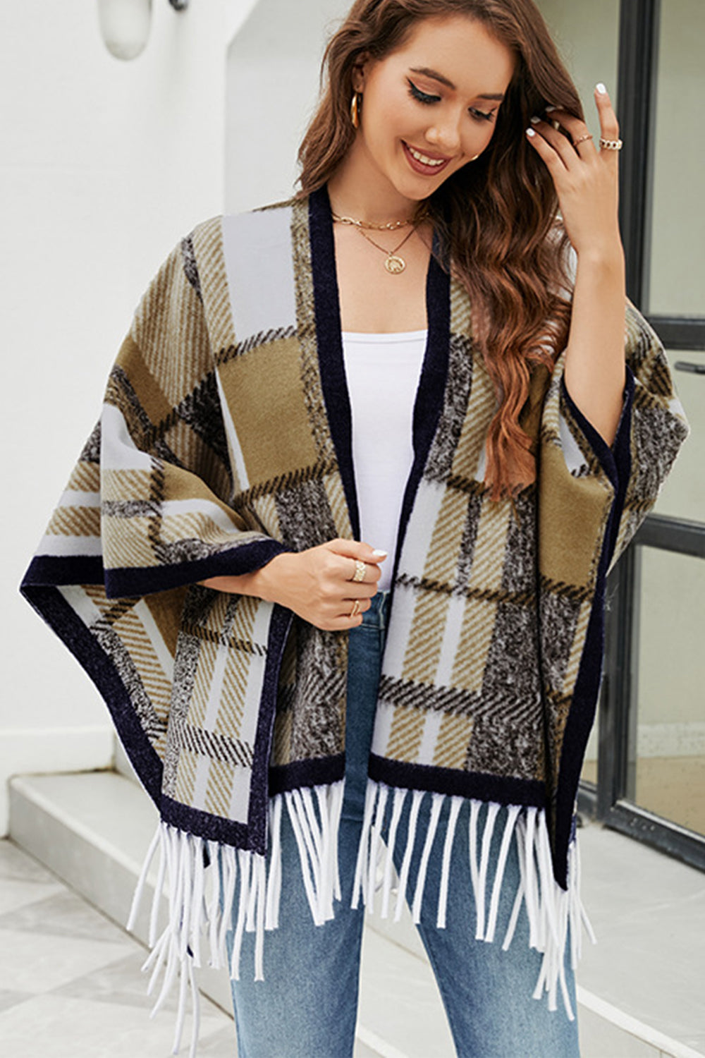 Cloak Sleeve Fringe Detail Poncho featuring a stylish plaid pattern and long sleeves, perfect for casual and classy occasions.