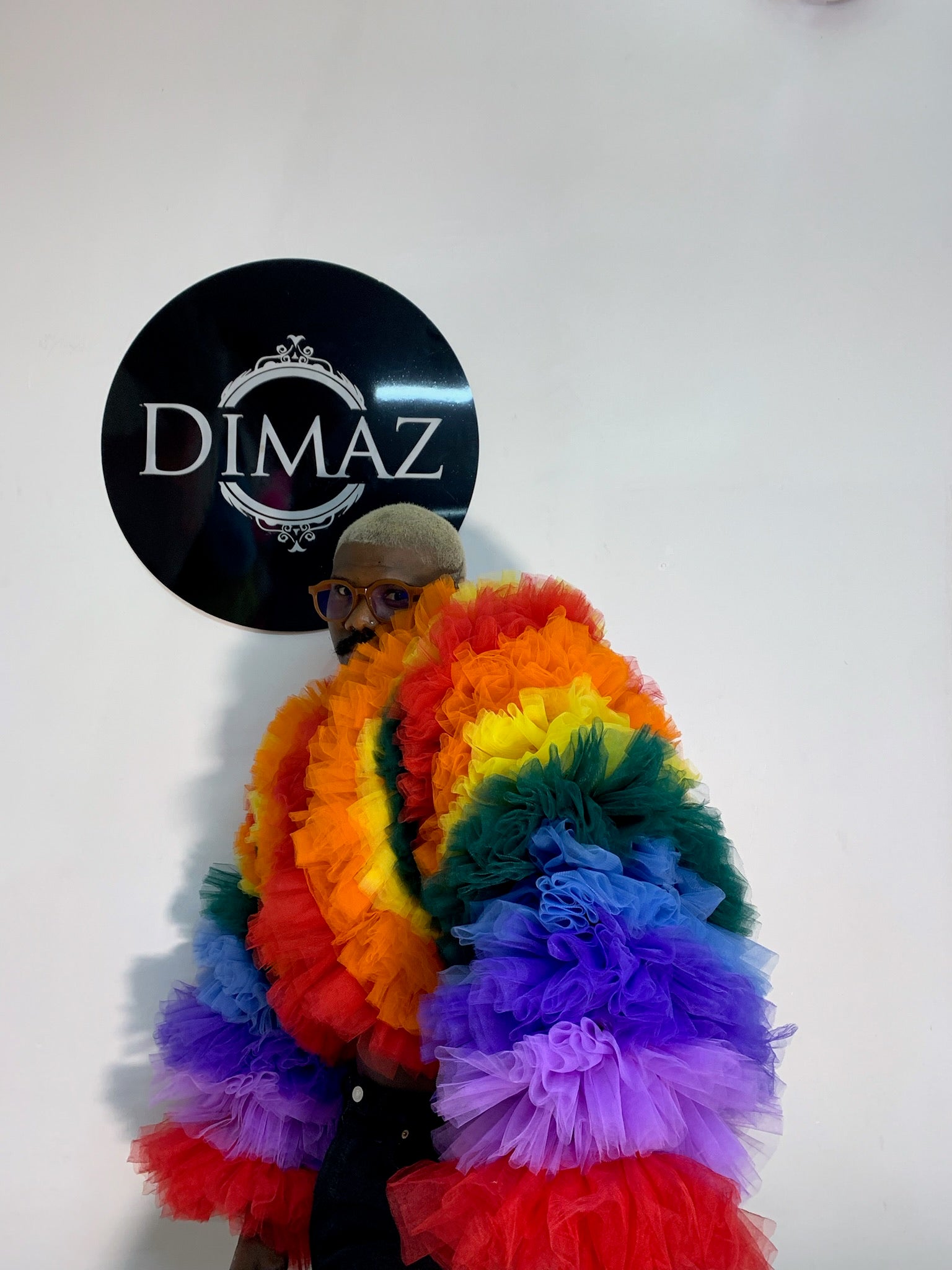 A vibrant Rainbow Ruffle Tulle Long Sleeve Jacket featuring cascading ruffles in a spectrum of colors, perfect for making a fashion statement.