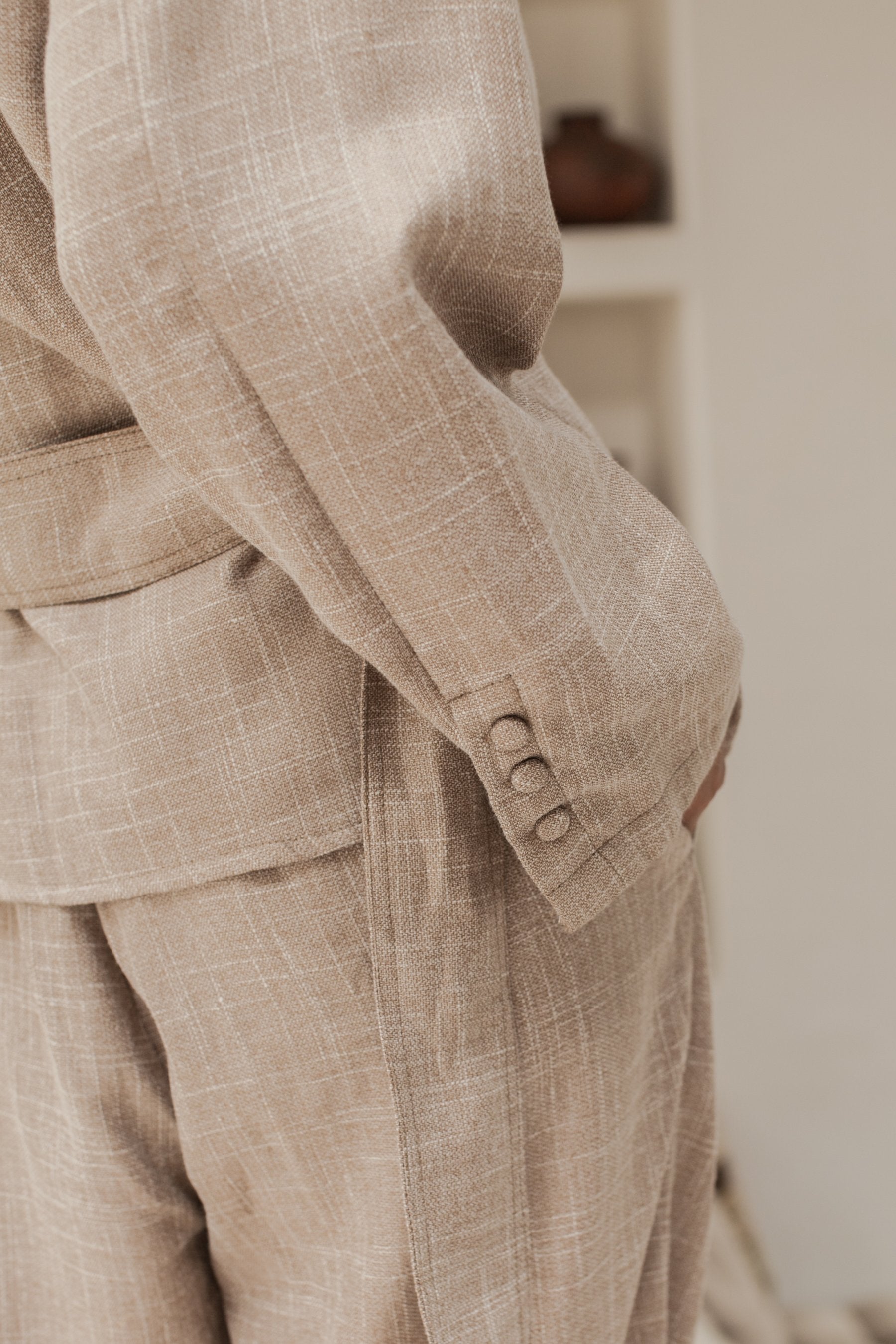 Coco Cotton Belted Blazer in Latte color, featuring structured shoulders and a matching tie belt, styled elegantly.