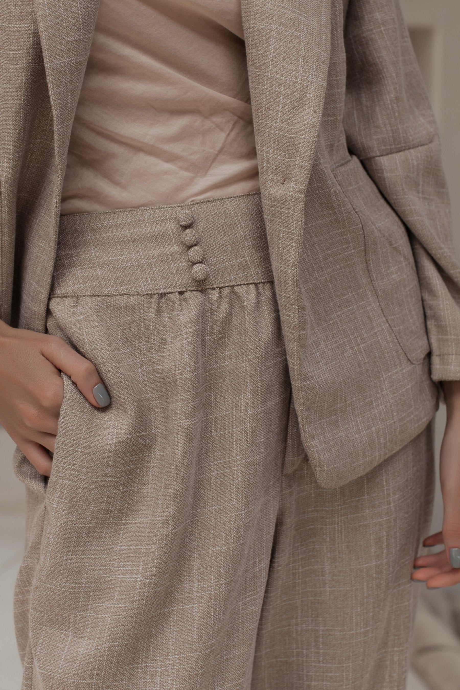 Coco Cotton Belted Blazer in Latte color, featuring structured shoulders and a matching tie belt, styled elegantly.