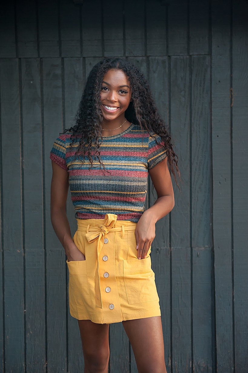 Coconut Button Solid Woven Skirt in Mustard with belt and accent pockets, displayed on a model.