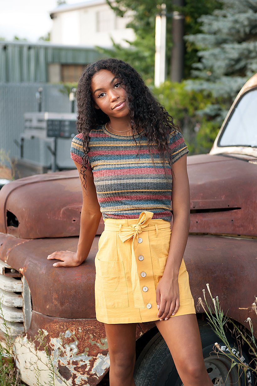 Coconut Button Solid Woven Skirt in Mustard with belt and accent pockets, displayed on a model.