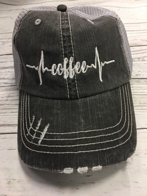 Coffee Heartbeat Trucker Hat featuring a stylish embroidered design, made of herringbone fabric with a Velcro closure.