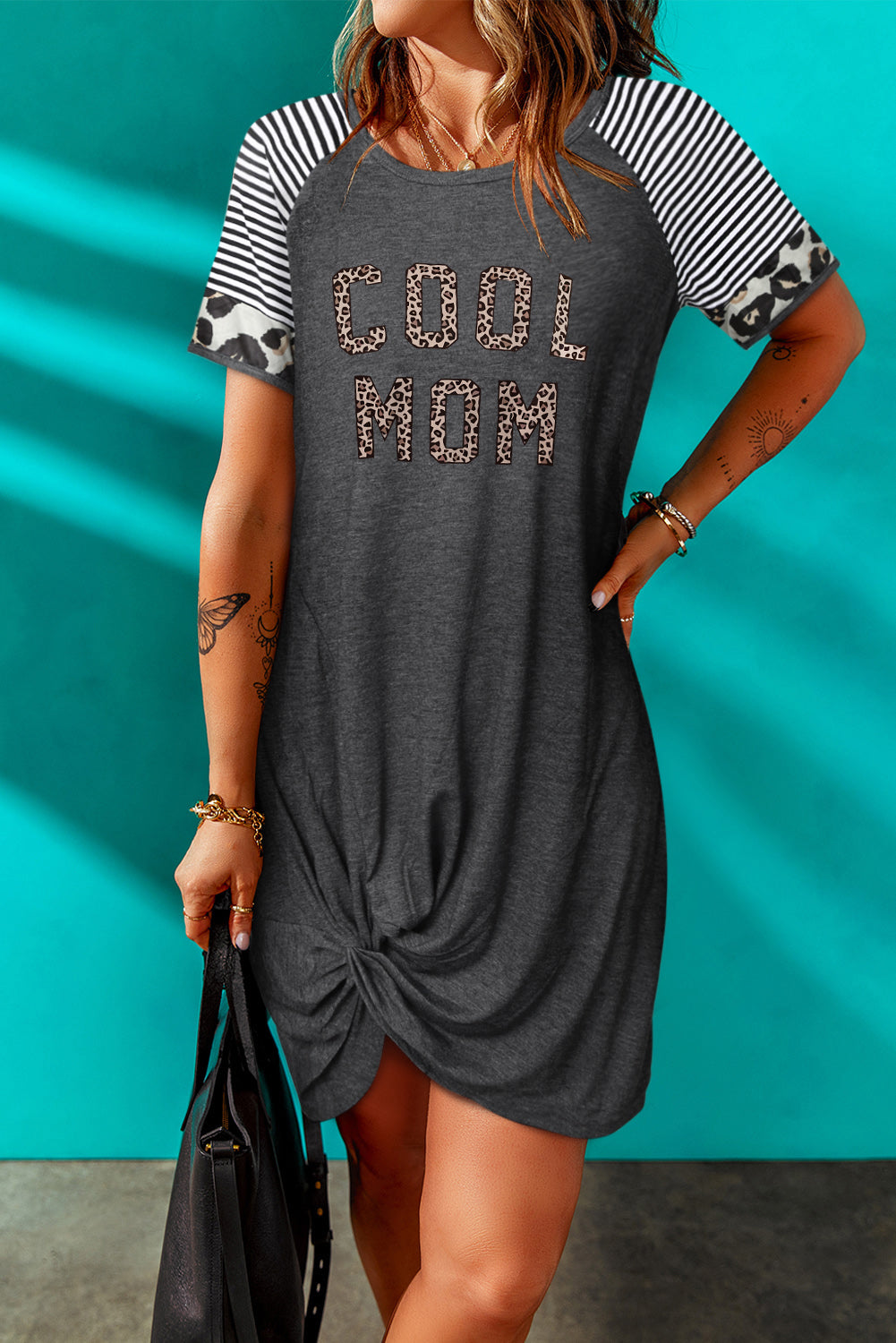 A stylish COOL MOM Graphic Twisted Dress featuring a striped and leopard pattern, with a round neck and asymmetrical hem.