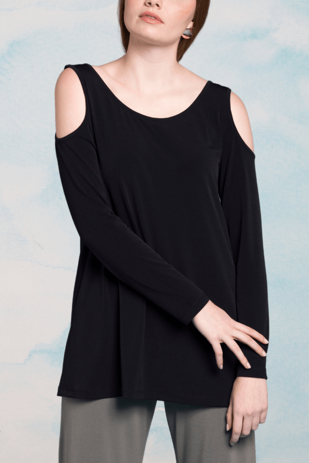 A stylish cold shoulder tunic with a scoop neckline, featuring a relaxed fit and straight hemline, perfect for casual or dressy occasions.