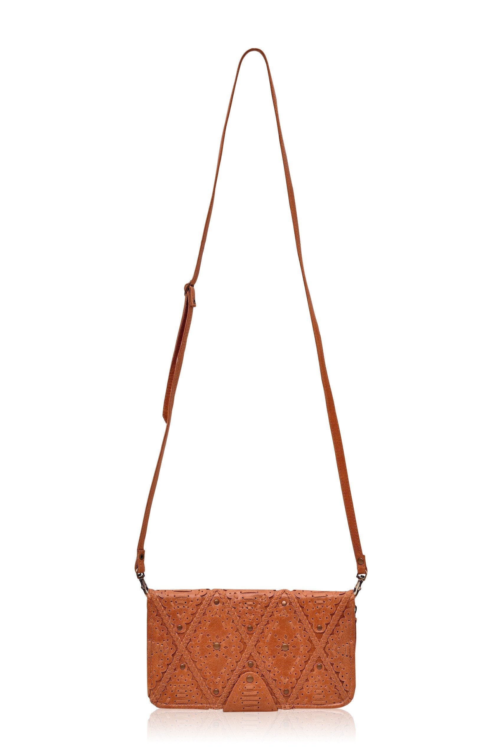 Colibri Leather Crossbody Clutch featuring intricate cut-out work and leather stitching, available in various colors.