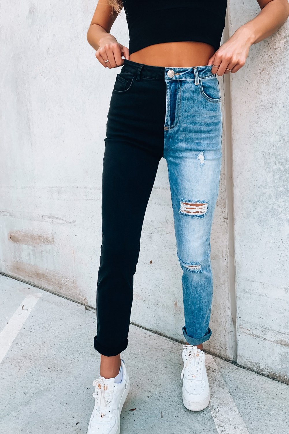 A pair of stylish Color Block Distressed Skinny Jeans featuring contrasting colors and distressed details, perfect for modern ladies.