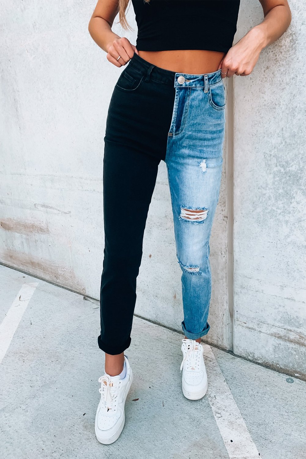 A pair of stylish Color Block Distressed Skinny Jeans featuring contrasting colors and distressed details, perfect for modern ladies.