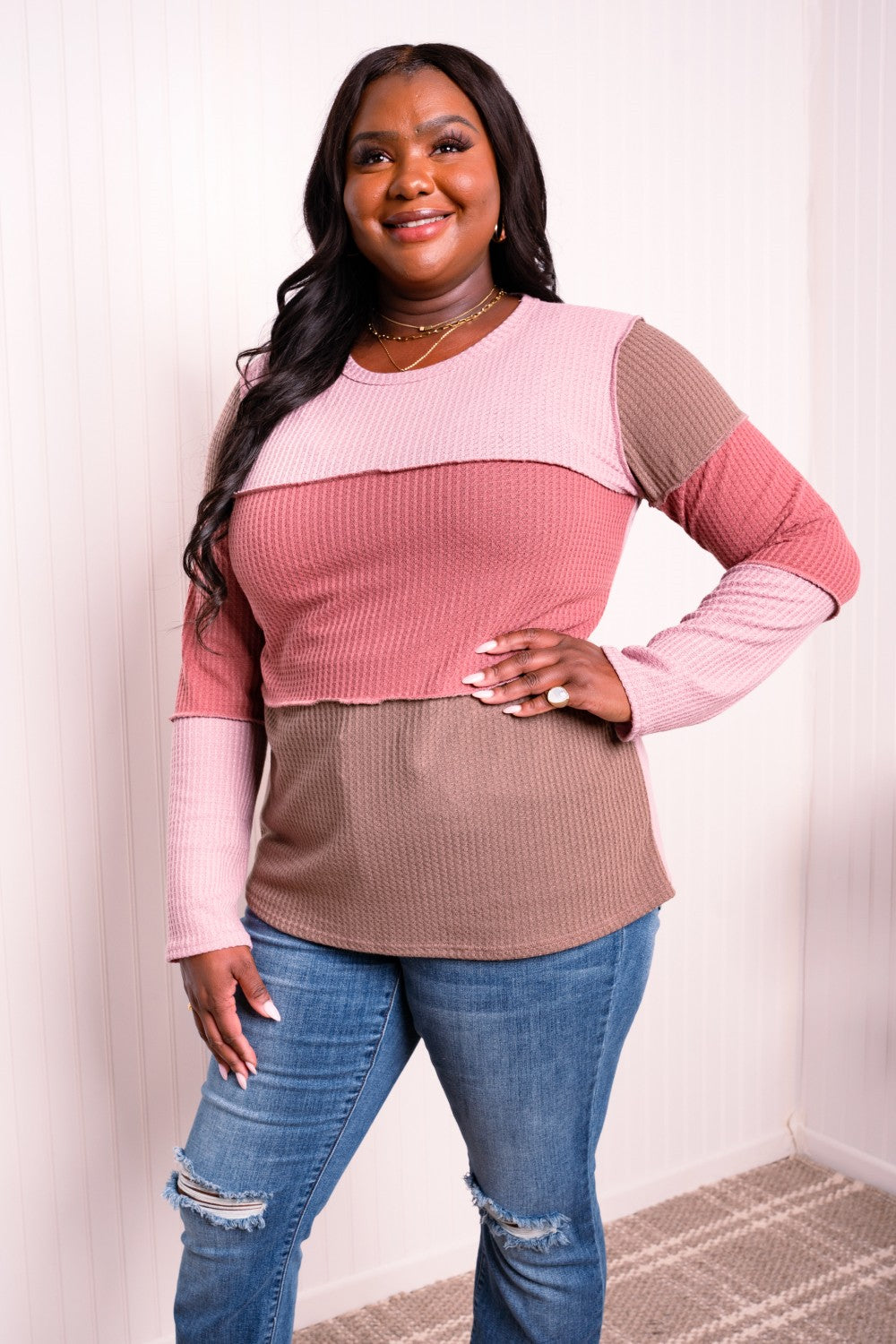 A stylish color block waffle-knit top featuring exposed seams, round neckline, and long sleeves, perfect for casual wear.