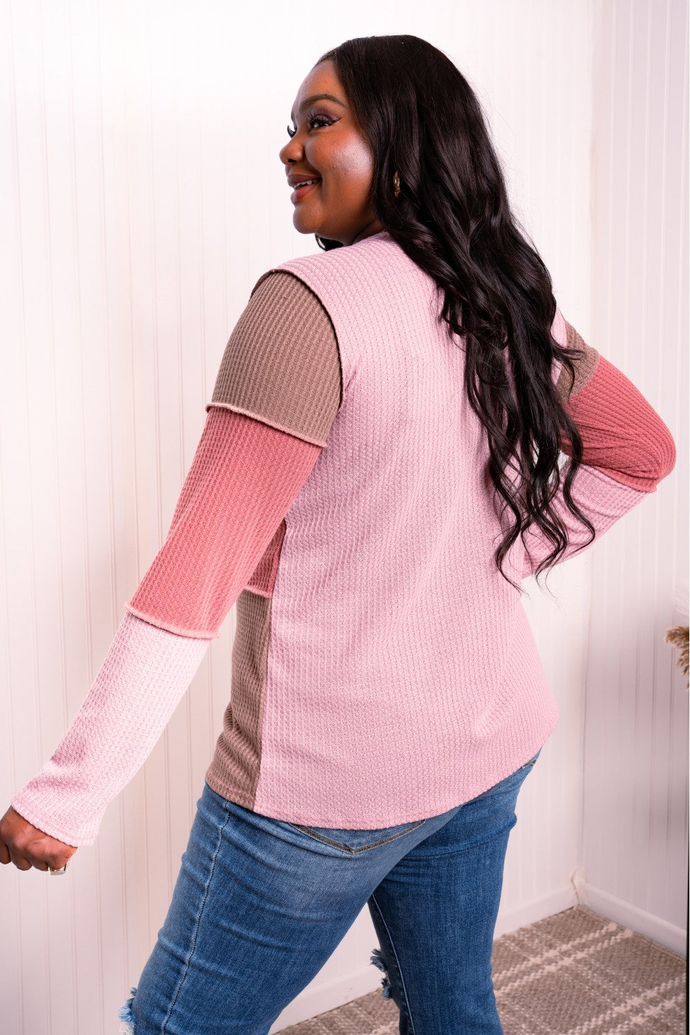 A stylish color block waffle-knit top featuring exposed seams, round neckline, and long sleeves, perfect for casual wear.