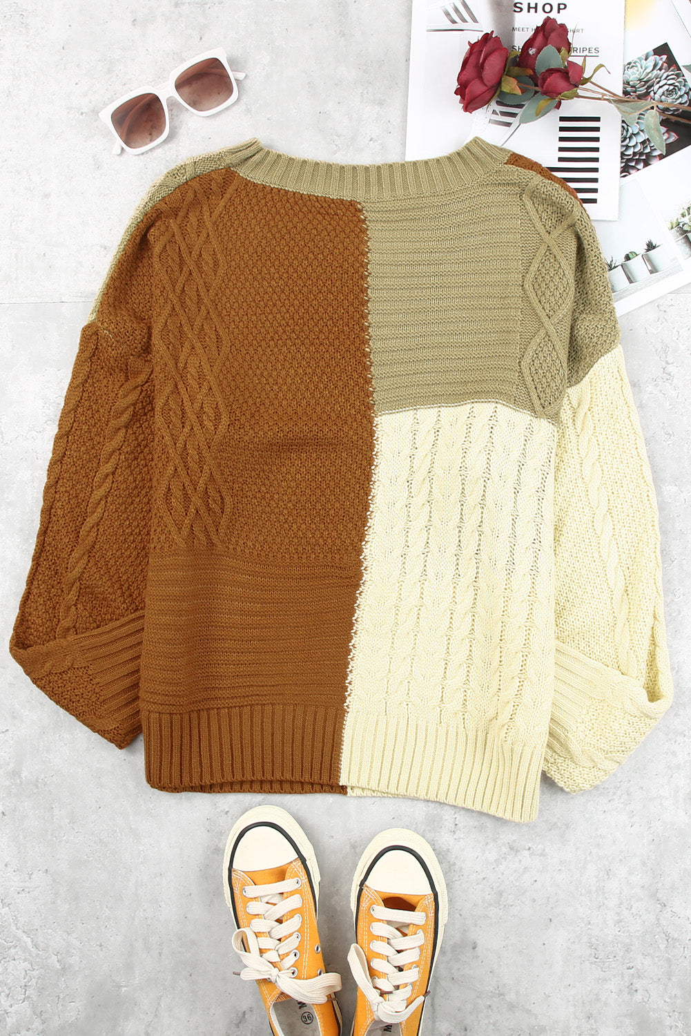 Color Block Mixed Knit Sweater displayed in a flat lay outdoors, showcasing its chic design and vibrant colors.