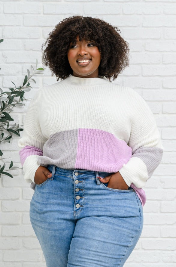 Lavender color block top featuring a mock neck design, showcasing three wintery shades in a cozy knit material.