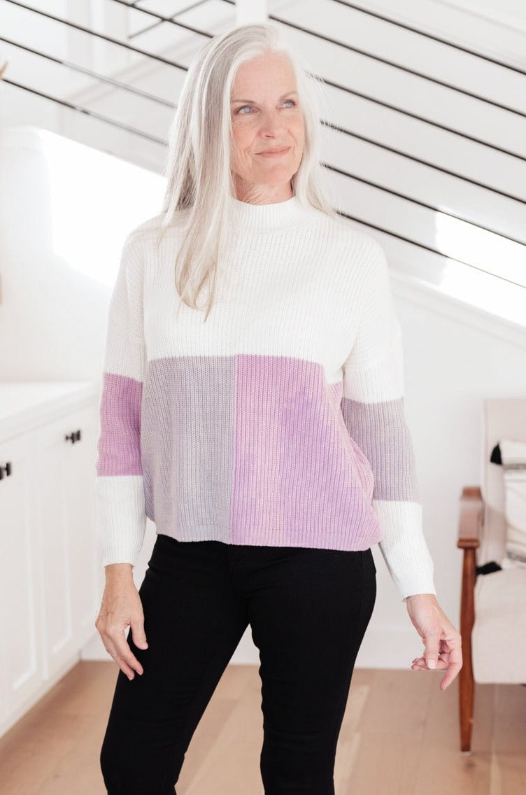 Lavender color block top featuring a mock neck design, showcasing three wintery shades in a cozy knit material.