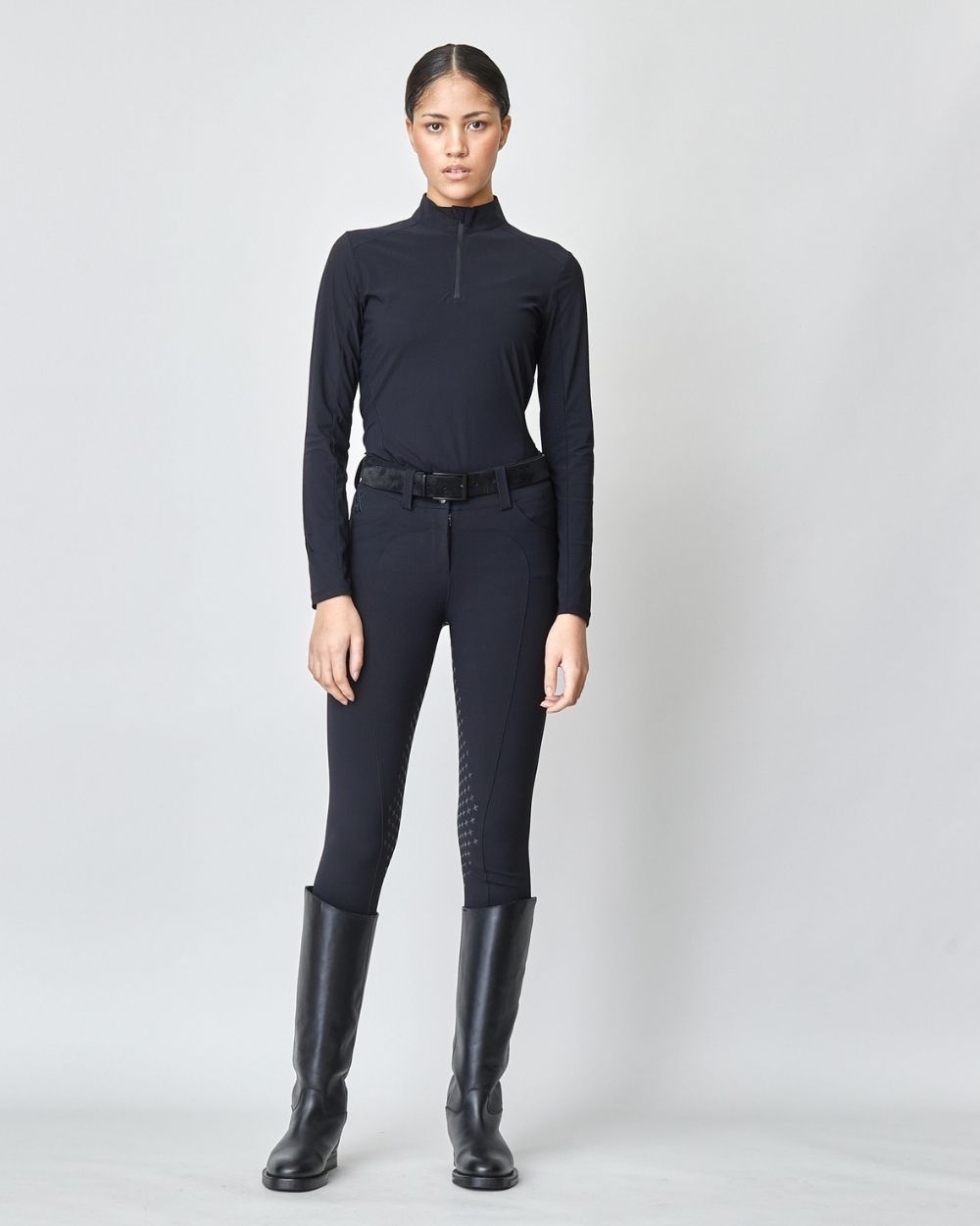 A pair of black Compression Performance Breeches featuring a sleek design, belt loops, and two front pockets, ideal for equestrian activities.