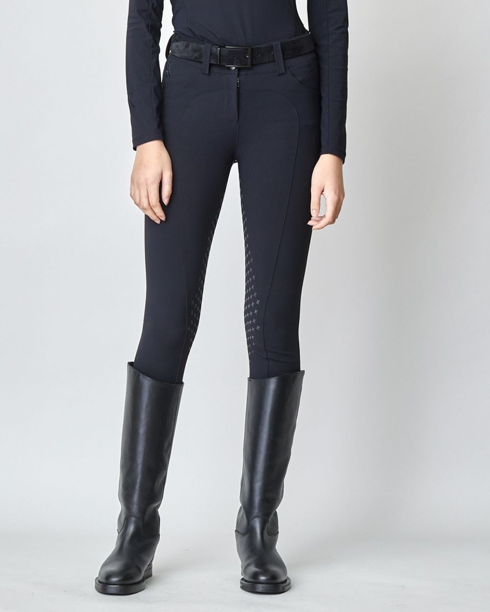 A pair of black Compression Performance Breeches featuring a sleek design, belt loops, and two front pockets, ideal for equestrian activities.