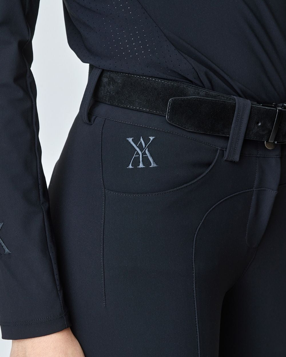 A pair of black Compression Performance Breeches featuring a sleek design, belt loops, and two front pockets, ideal for equestrian activities.