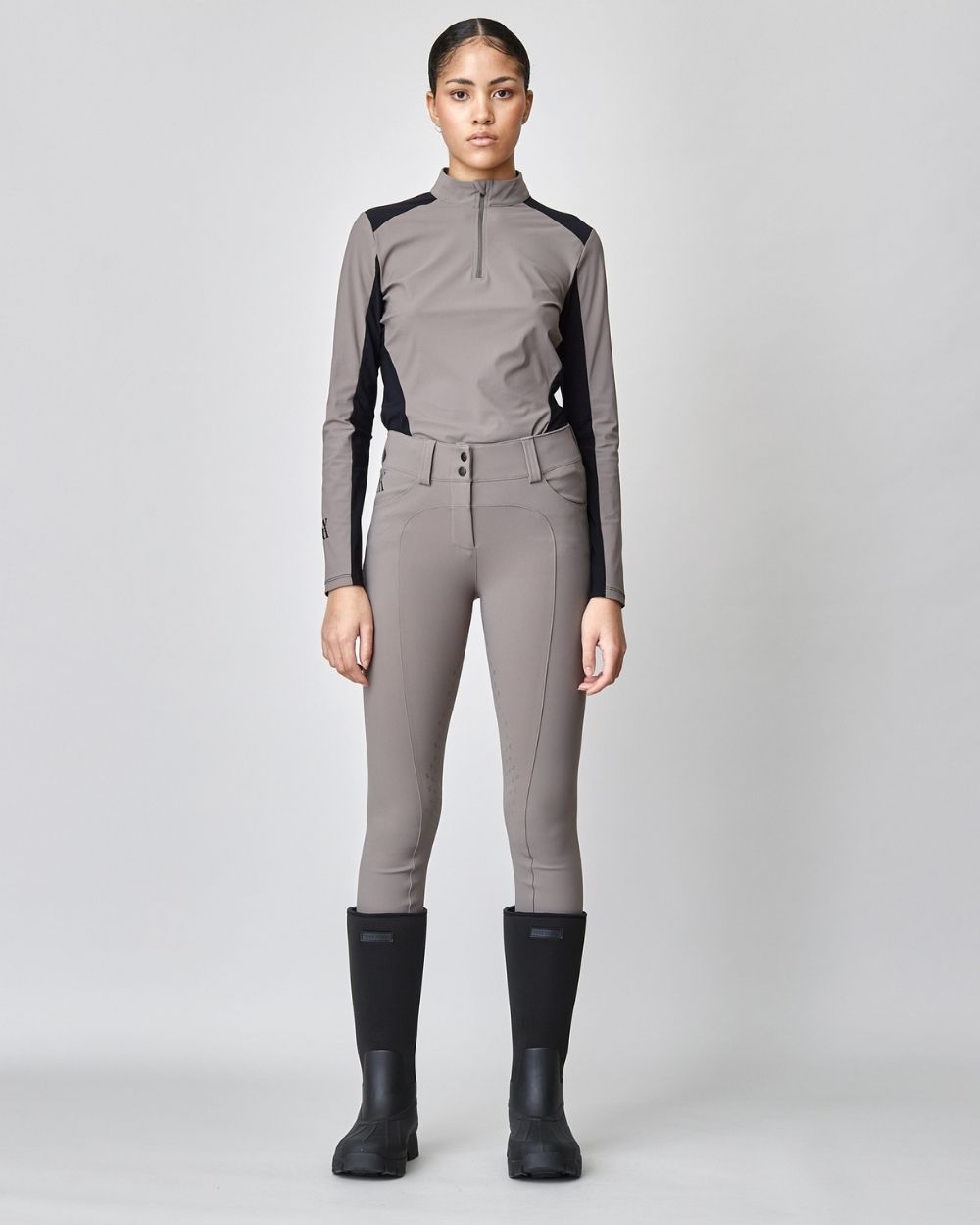 Taupe Compression Performance Breeches featuring a sculpting design, zipper, and belt loops, ideal for equestrian activities.