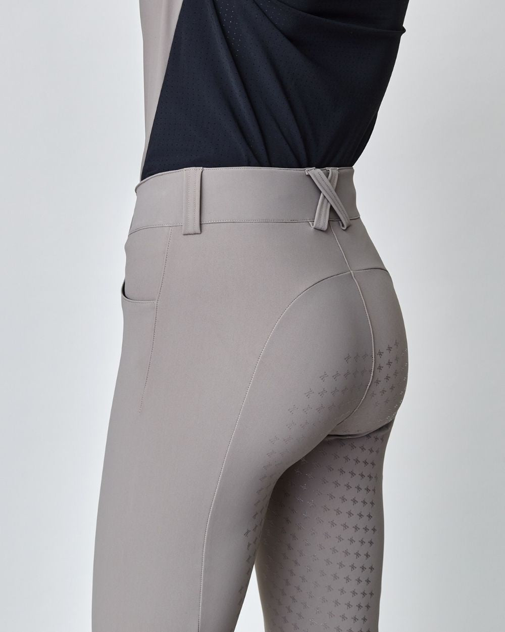 Taupe Compression Performance Breeches featuring a sculpting design, zipper, and belt loops, ideal for equestrian activities.