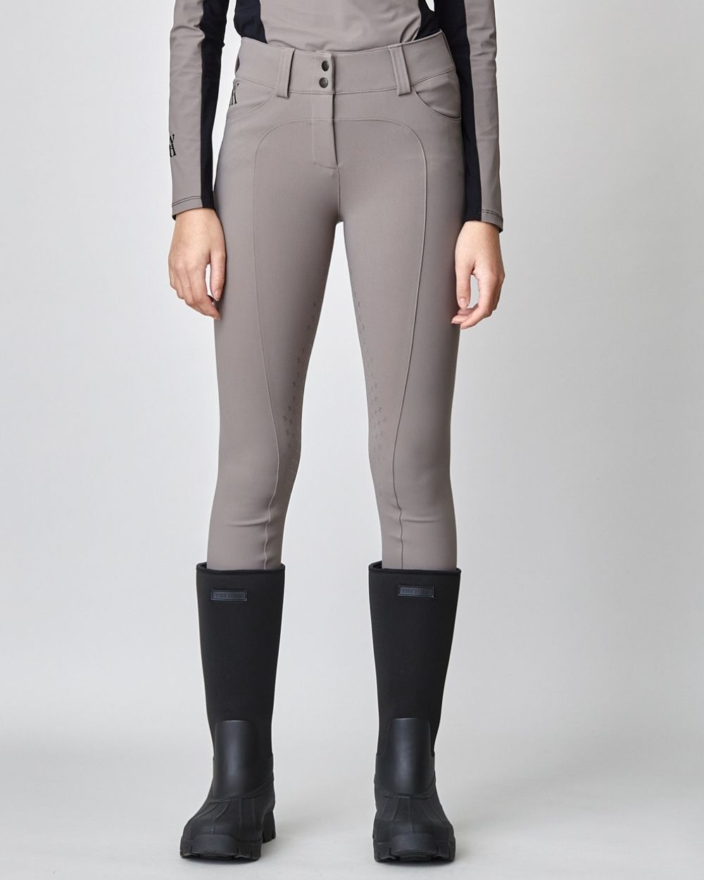 Taupe Compression Performance Breeches featuring a sculpting design, zipper, and belt loops, ideal for equestrian activities.