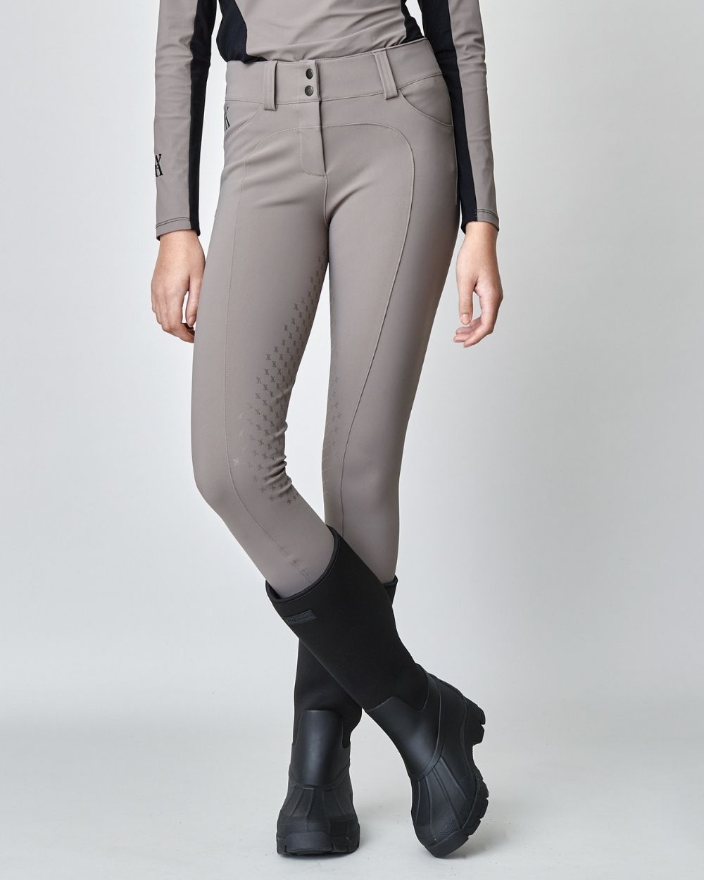 Taupe Compression Performance Breeches featuring a sculpting design, zipper, and belt loops, ideal for equestrian activities.