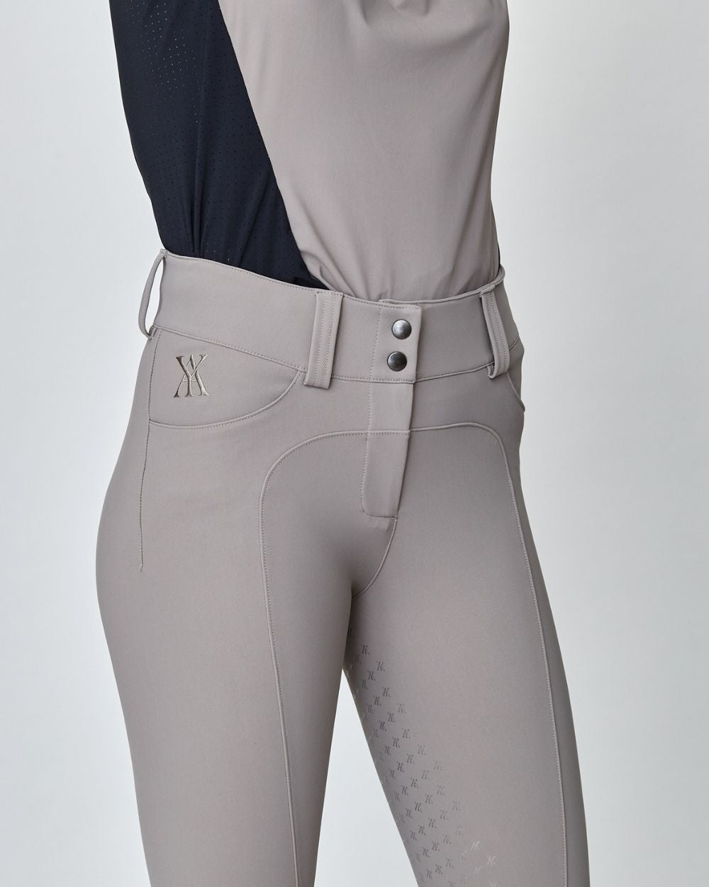 Taupe Compression Performance Breeches featuring a sculpting design, zipper, and belt loops, ideal for equestrian activities.