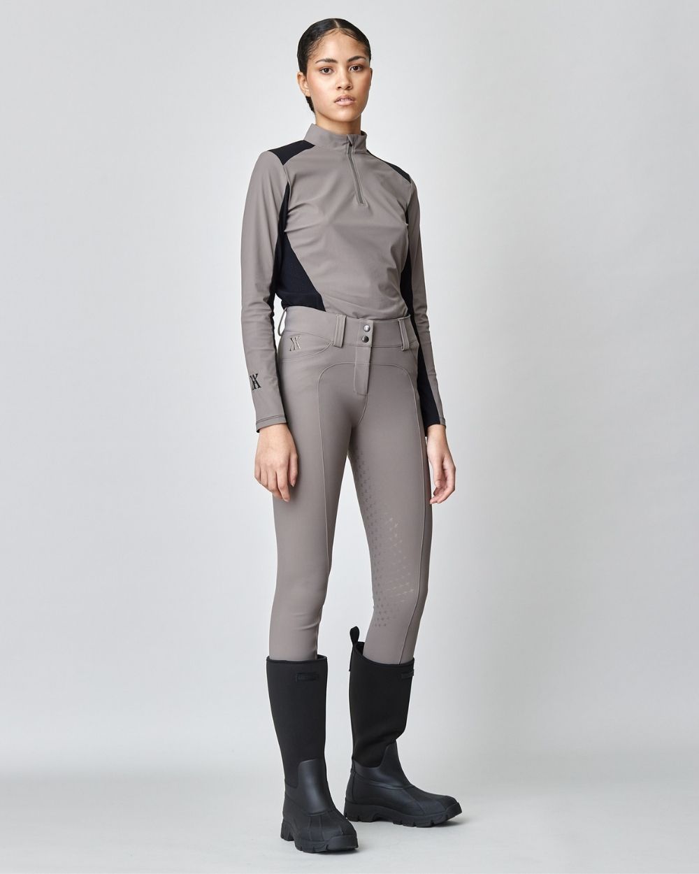 Taupe Compression Performance Breeches featuring a sculpting design, zipper, and belt loops, ideal for equestrian activities.