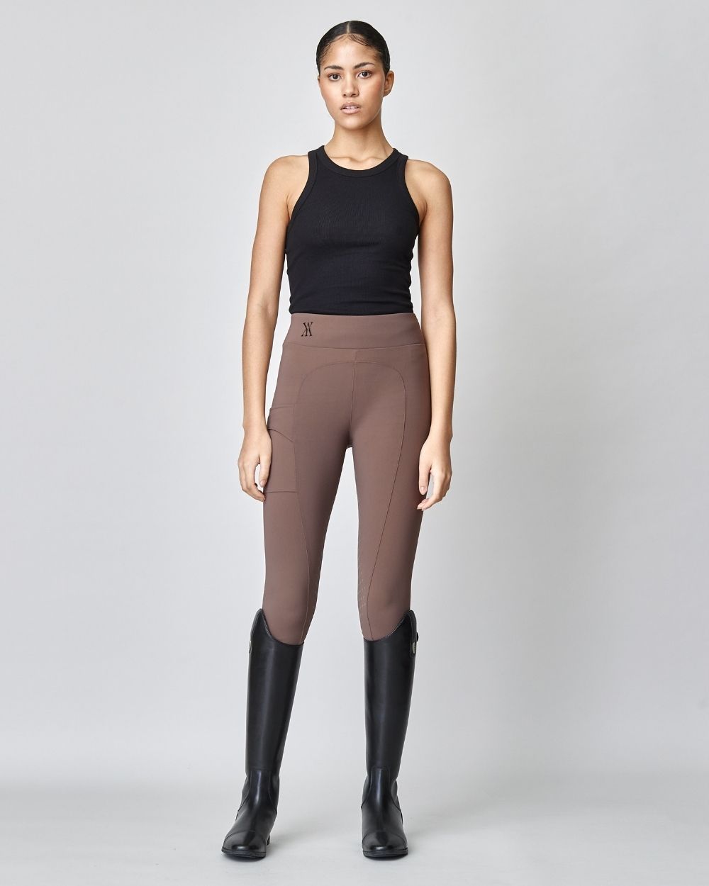 Brown Compression Pull-On Breeches designed for equestrian performance, featuring a high waist and discreet mobile phone pocket.