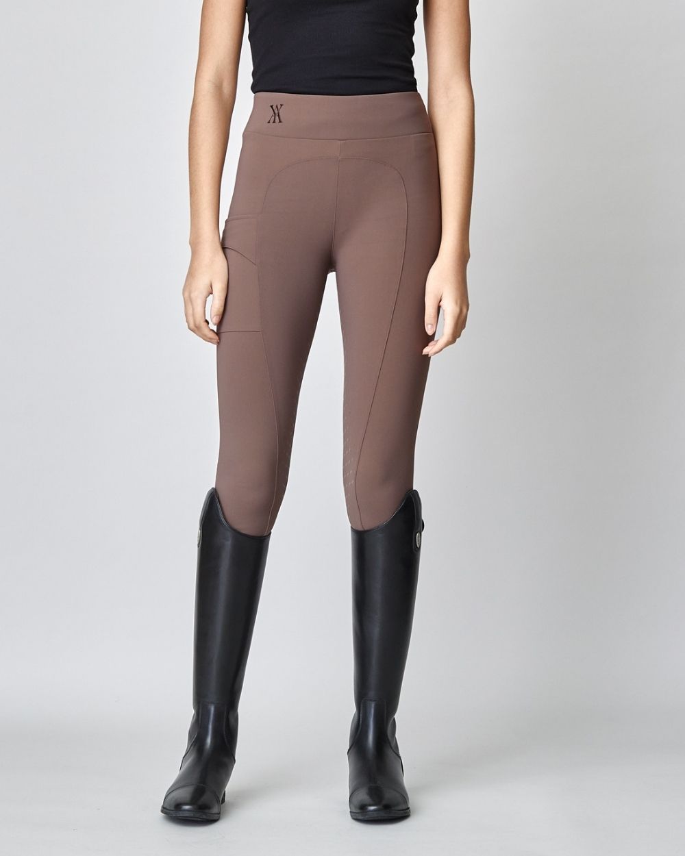 Brown Compression Pull-On Breeches designed for equestrian performance, featuring a high waist and discreet mobile phone pocket.