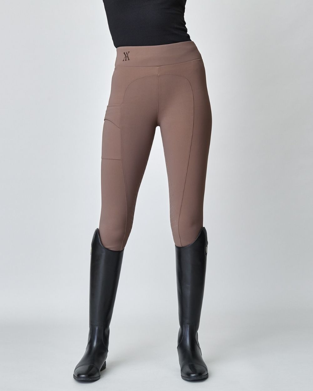 Brown Compression Pull-On Breeches designed for equestrian performance, featuring a high waist and discreet mobile phone pocket.