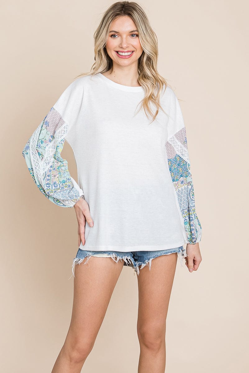 Contrasting Blossom Sleeve Waffle Knit Top featuring floral patchwork sleeves and a boat neck design, perfect for casual wear.