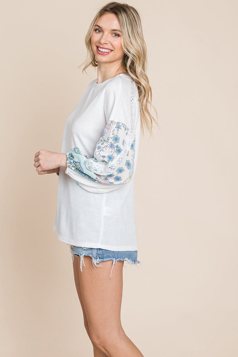 Contrasting Blossom Sleeve Waffle Knit Top featuring floral patchwork sleeves and a boat neck design, perfect for casual wear.